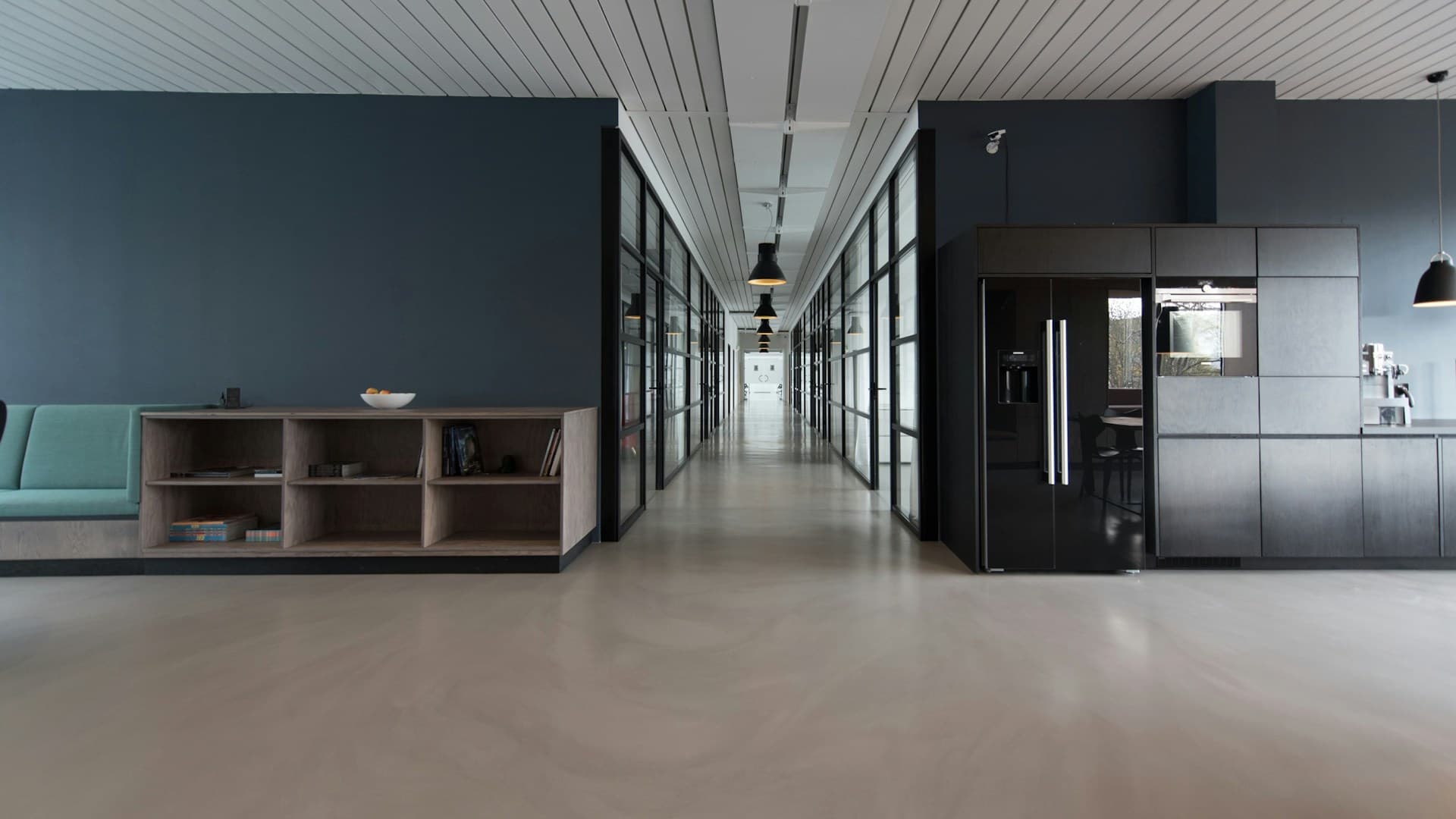 Inside Muze Office Las Vegas — open coworking area with desks, natural light, and members working alongside the on-site cafe